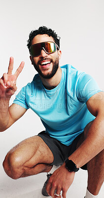 Buy stock photo Studio, athlete and man with sport sunglasses, peace sign and happiness for UV protection spectacles. White background, glare reduction and person with smile for eyewear, eye care and visual shield