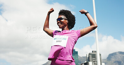 Buy stock photo Black woman, marathon and celebration with winning at finish line with low angle, goals and performance. Person, champion and happy runner with achievement, success and fist pump for sports milestone