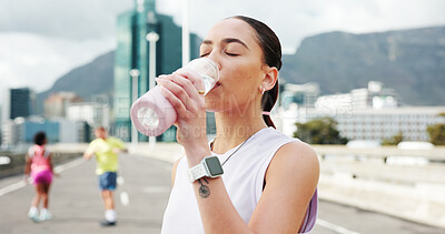 Buy stock photo Woman, fitness and drinking with water bottle in city for workout break, rest or recovery. Active, female person or runner with mineral liquid, aqua or beverage for sports hydration in an urban town