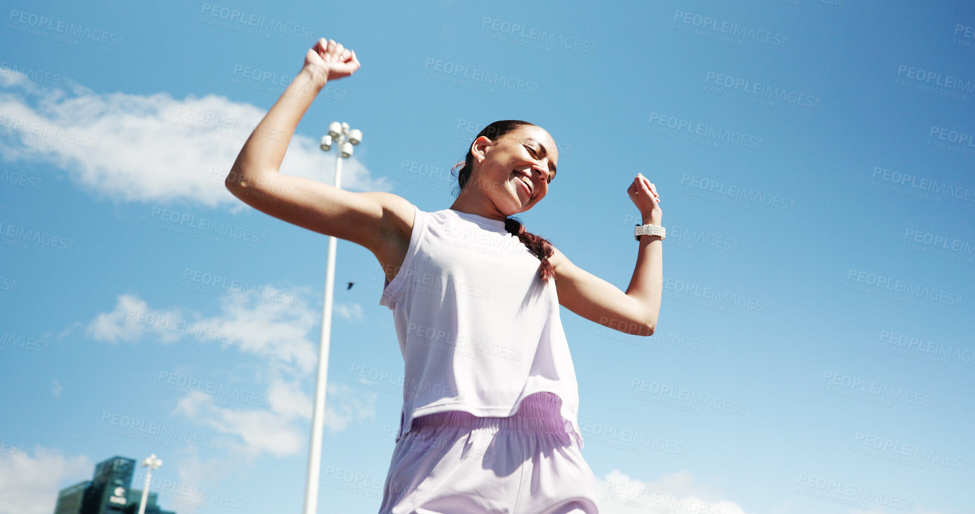 Buy stock photo Happy woman, runner and winning race in city for fitness challenge, marathon or competition. Active, female person or winner with smile or fist pump for sport, sprint or victory in an urban town