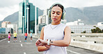 Headphones, smart watch and woman in city for exercise, marathon training and tracking workout. Sports, athlete and person with tech for wellness, health stats and music for fitness in urban town