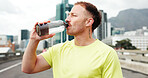 Man, fitness and drinking with water bottle in city for workout break, rest or recovery. Active, male person or runner with mineral liquid, aqua or beverage for sports hydration in an urban town
