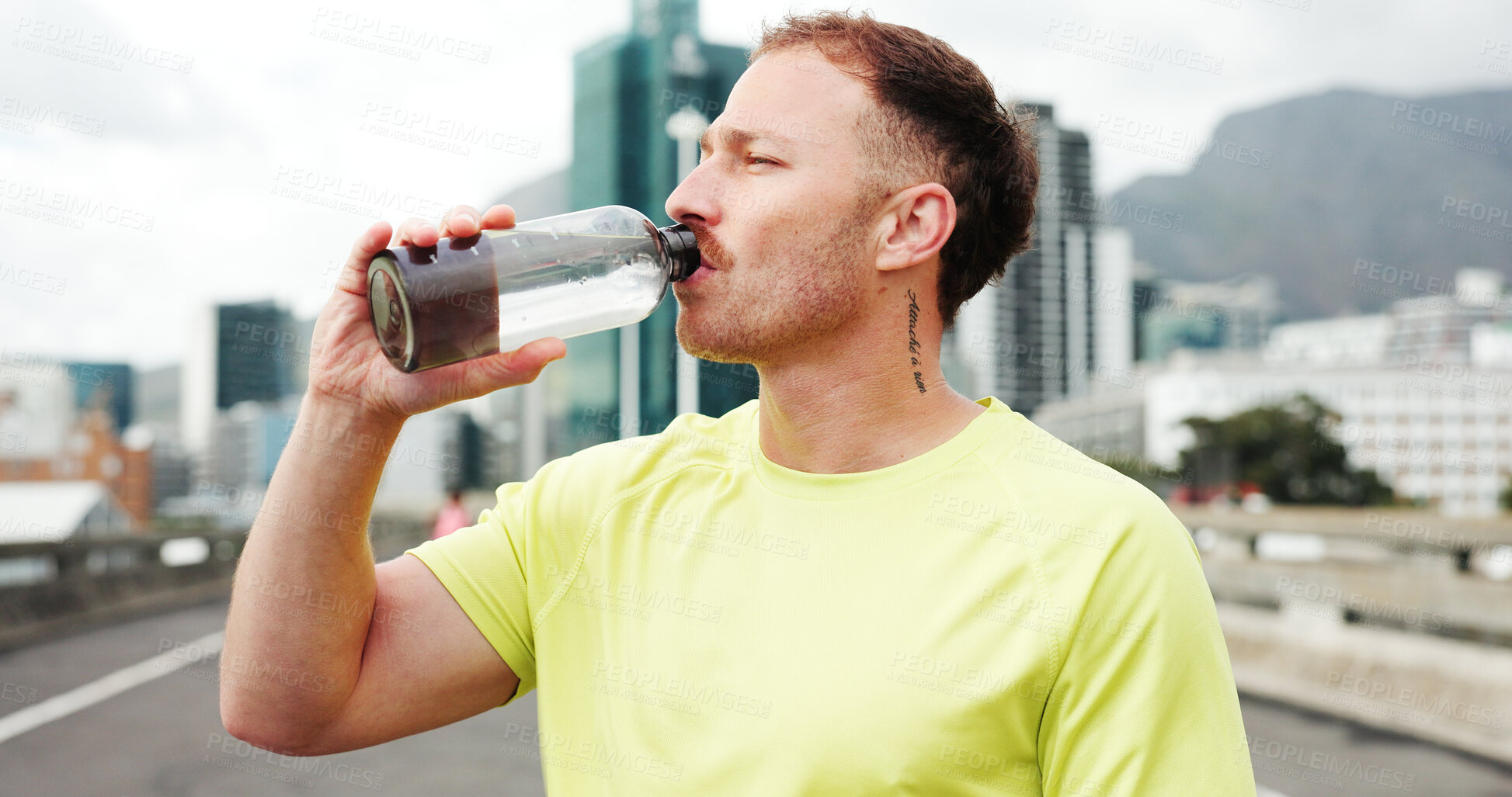 Buy stock photo Man, fitness and drinking with water bottle in city for workout break, rest or recovery. Active, male person or runner with mineral liquid, aqua or beverage for sports hydration in an urban town
