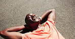 Tired, fitness and above of black man in road for rest, recovery and relax for exercise, workout or training. Sports, outdoor and person with fatigue in town for health, wellness and break for cardio