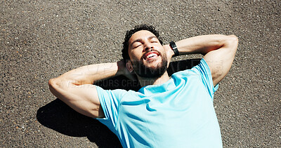 Buy stock photo Relax, exercise and above of man in road for rest, recovery and tired for fitness, workout and training. Sports, happy and person with fatigue lying in city for health, wellness and break outdoor