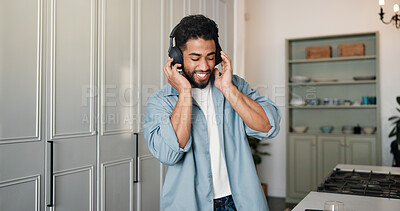 Buy stock photo Music, dance and man in house with headphones, podcast or listening on audio app. Happy, sound track and Indian person in kitchen with technology, media or radio streaming on virtual subscription.