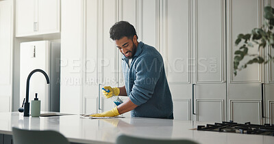 Buy stock photo Smile, cleaning and cloth with man and kitchen counter for germ prevention, hygiene and disinfection. Bacteria, protection and chores with antibacterial bottle and person in home for wipe surface