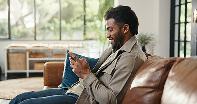 Buy stock photo Home, smartphone and man on couch, smile and social media with online humor, app and texting. Apartment, cellphone or person with happiness, email and connection with network, relax and communication