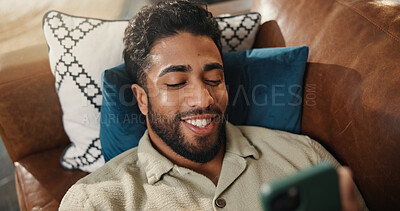 Buy stock photo Home, smartphone and man in lounge, smile and social media with online comedy. Apartment, cellphone and person with happiness, email notification and connection with network, communication or texting