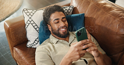 Buy stock photo Home, above and man on couch, smartphone and online reading with communication. Cellphone, relax and person with happiness, email notification and connection with internet, app and message to contact