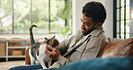 Love, stroke and man on sofa with cat, fur rub and animal bonding on weekend break. Happy, relax and male person in house with kitten, feline best friend and pet affection on Sunday rest.