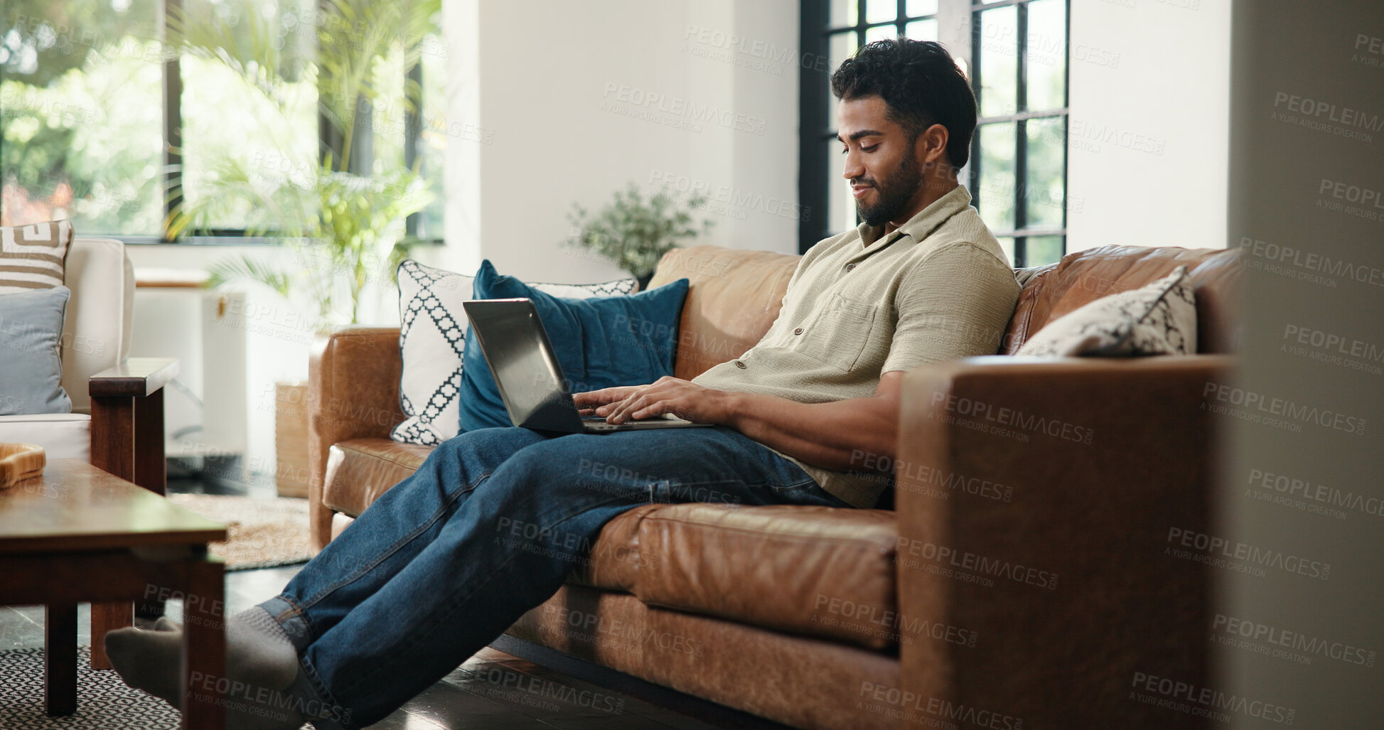 Buy stock photo Creative, typing and man with laptop, lounge and email marketing on website, online and remote work. Home, brand awareness and self publisher with tech for novel promotion, app and person on couch