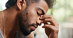 Headache, frustration and man in home with fatigue, depression or mistake with financial crisis. Tired, regret and male person with migraine for mental health, pressure or burnout in apartment.