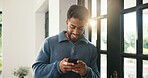 Window, typing and happy man with phone, browsing internet and check social media post. Message notification, texting and person in home with mobile app, online communication and reply to comment.