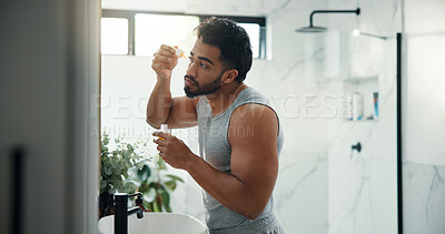 Buy stock photo Man, dropper and serum for skincare in bathroom for hydration, beard growth and self care. Male person, cosmetics and essential oil with collagen benefits, facial shine and hair maintenance at house