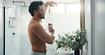Man, spray armpit and bathroom mirror in home with smile, fragrance and flare with morning routine. Person, grooming and self care with deodorant for odor, sweat or happy with bottle at apartment