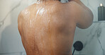 Back, water and person in bathroom, cleaning and shower with morning routine, wellness and wet. Home, washing and liquid with aqua, hygiene and clean body with healthy skin, grooming and beauty