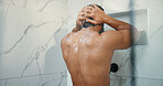 Water, hygiene and back of man in shower in bathroom for germs, dirt or bacteria removal with body care. Grooming, dermatology and person washing skin for health, wellness or morning routine in home.