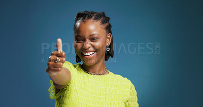 Buy stock photo Happy, black woman and portrait with thumbs up in studio for good job on a blue background. Female person, model or smile with like emoji, yes sign or OK for well done, thank you or feedback on space