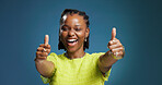 Excited, black woman and portrait with thumbs up in studio for good job on a blue background. Female person, model or smile with like emoji, yes sign or OK for well done, thank you or review on space