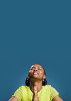 Black woman, hope and prayer hands with space in studio for luck on a blue background. Female person, model or faith with desire, expectation or dream for slight chance, wish or miracle on mockup