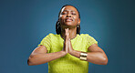 Black woman, hope and prayer hands with faith in studio for luck or worship on a blue background. Female person, model or christian with desire, expectation or dream for chance, wish or miracle
