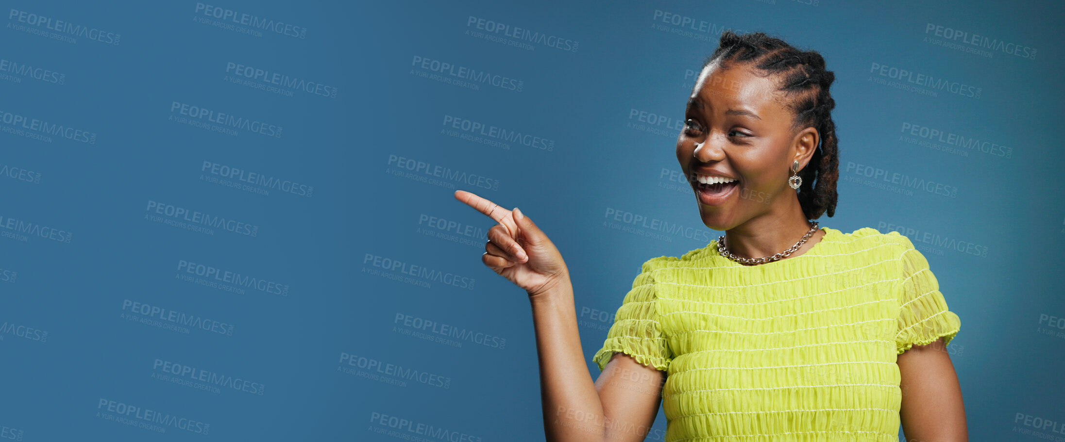 Buy stock photo Portrait, pointing and African woman with smile in studio, show announcement or advertising with confidence. Banner, mockup space and person with hand gesture for promotion, happy or blue background