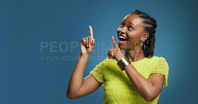 Buy stock photo Excited, pointing or happy woman in studio, show announcement or advertising alert with confidence. Offer info, mockup space or black person with hand gesture for promotion, smile or blue background