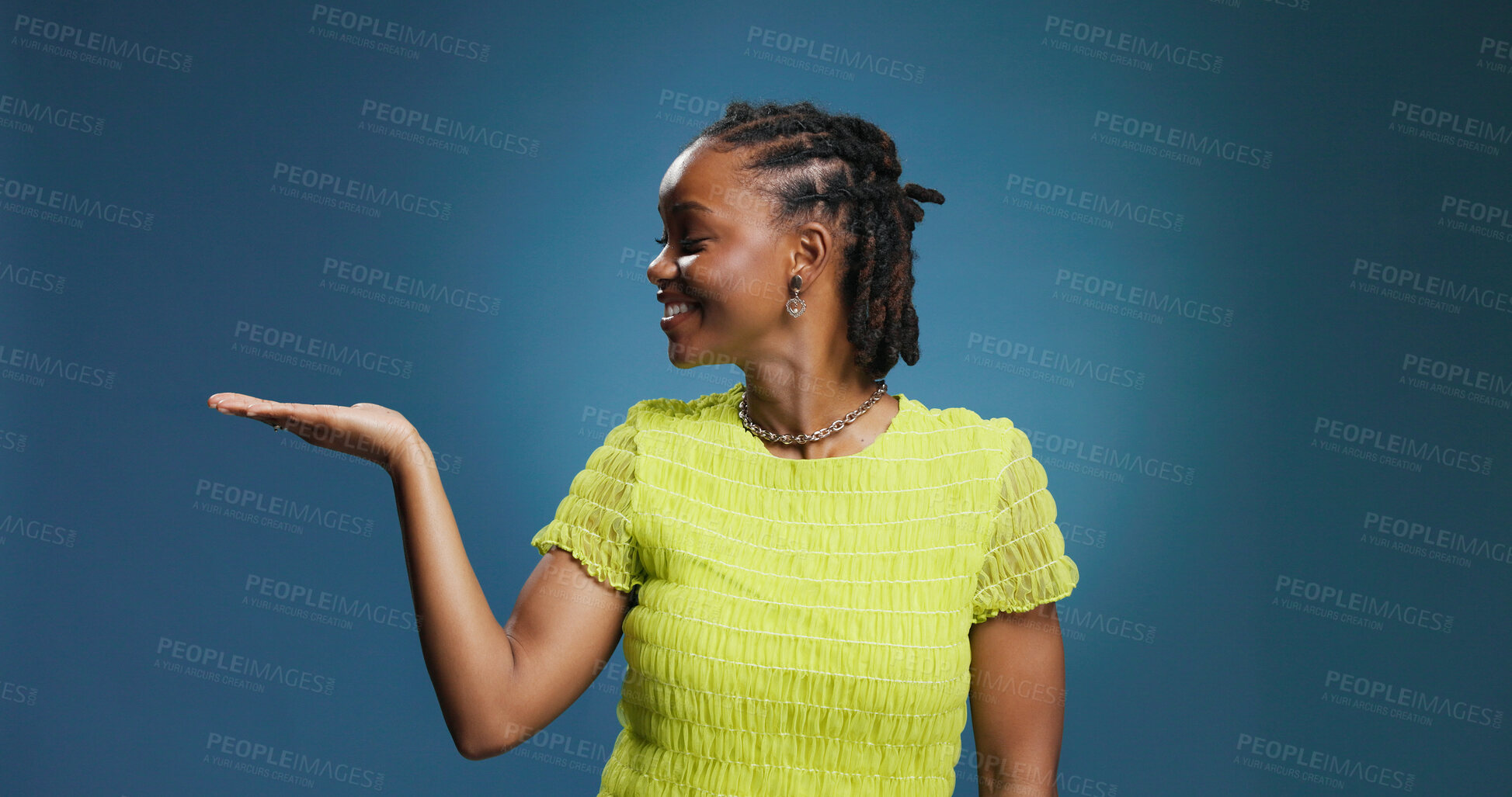 Buy stock photo Product placement, showing or happy woman in studio for advertising, launch announcement or promotion. Smile, space or African person with branding news for marketing, presentation or blue background