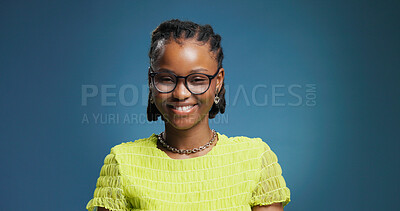 Buy stock photo Portrait, woman or college student in studio with glasses for fashion degree, learning or education. Space, person or smile with eyewear for creative study, university or knowledge on blue background