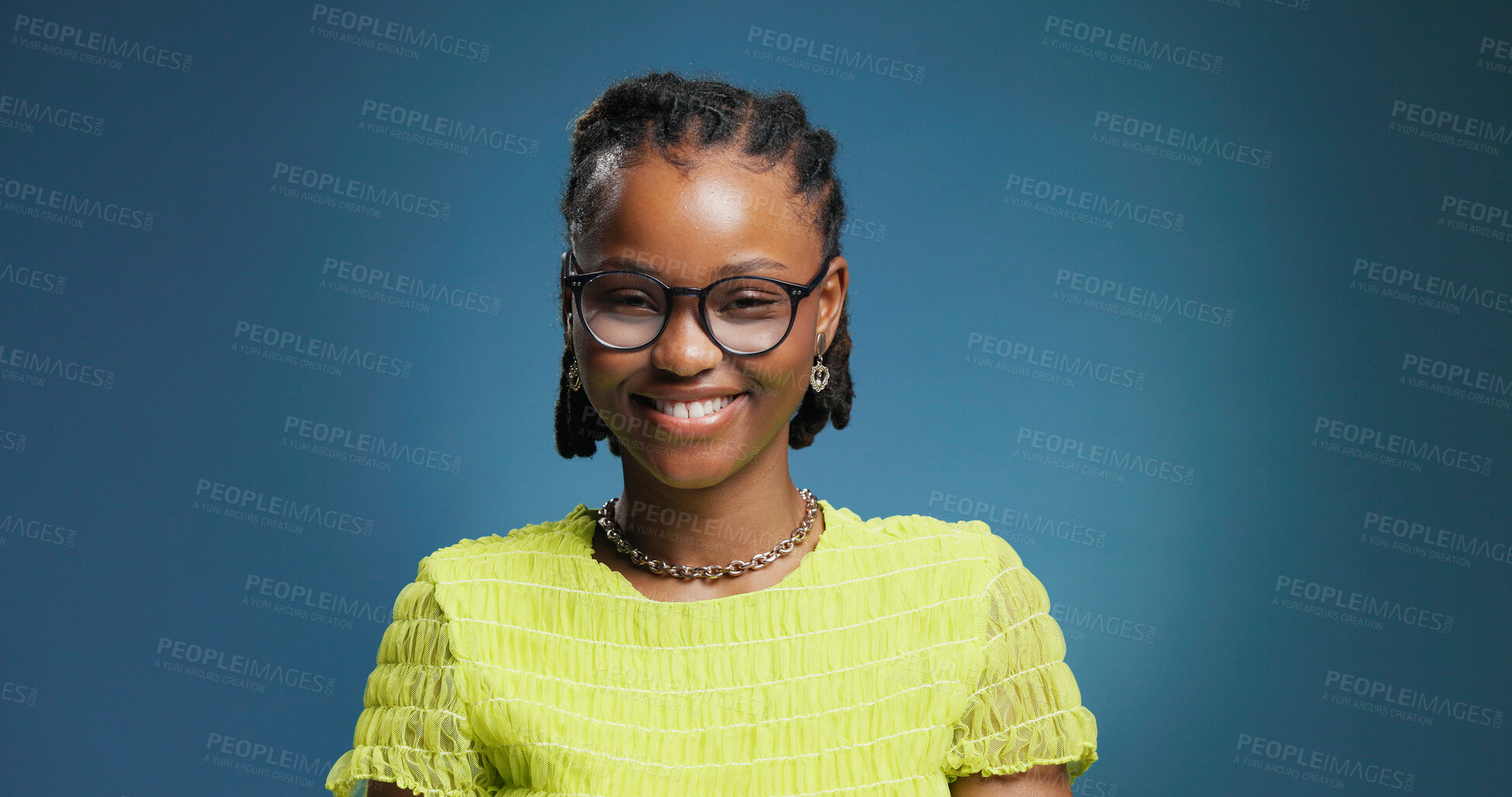Buy stock photo Portrait, woman or college student in studio with glasses for fashion degree, learning or education. Space, person or smile with eyewear for creative study, university or knowledge on blue background