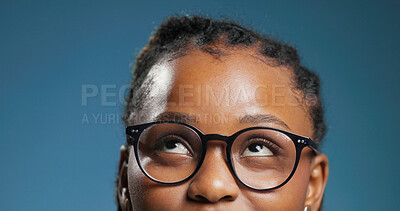Buy stock photo Black woman, student and thinking with glasses in studio for idea on a blue background. Thoughtful, female person or model with spectacles for problem solving, decision or choice for option or vision