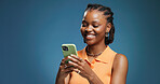 Typing, smartphone and black woman in studio, funny meme and network on blue background. Mockup space, mobile user and African person with cellphone, social media and message to contact and laughing