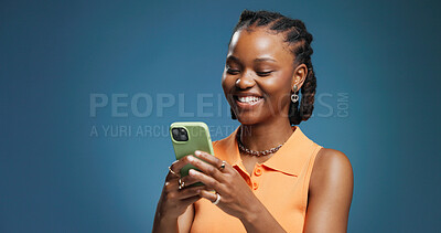Buy stock photo Typing, smartphone and black woman in studio, funny meme and network on blue background. Mockup space, mobile user and African person with cellphone, social media and message to contact and laughing
