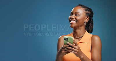 Buy stock photo Funny, smartphone and black woman in studio, internet and communication on blue background. Mockup space, laughing or African person with cellphone, network and app with email, joke and online comedy