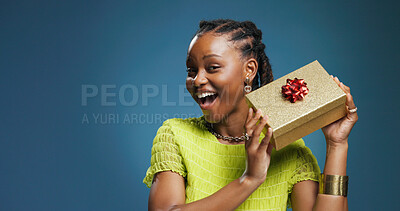 Buy stock photo Box, celebration and portrait with black woman on studio space for package or surprise gift. Present, ribbon and smile with excited African person isolated on blue background mockup for giveaway