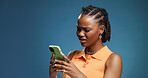 Confused, phone and text message with black woman in studio for fraud or phishing scam reaction. App, doubt and typing with African person on blue background for contact or fake news notification