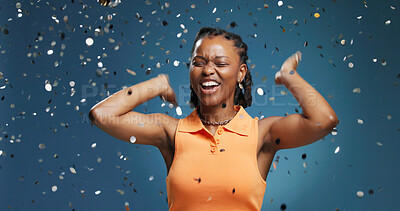 Buy stock photo Excited, confetti and black woman in studio, celebration and announcement on blue background. Happiness, success and African person with smile, glitter and milestone with achievement and good news