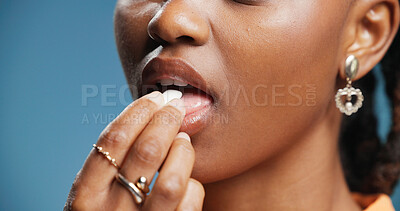 Buy stock photo Woman, mint or chewing gum in studio with mouth for fresh breath, dental hygiene or wellness. Person lips, bubblegum or peppermint candy for oral care, bacteria or teeth whitening on blue background.