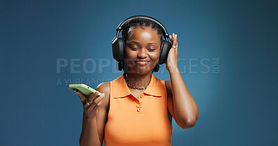 Buy stock photo Headphones, smile and black woman with studio background for phone, music and playlist. Listening, audio tech and African female person with break for album, radio or song for rhythm and groove