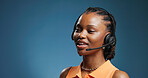 Happy, black woman and consultant with headset in studio for communication on a blue background. Female person, agent or model with mic for virtual assistance, help or call center support on space