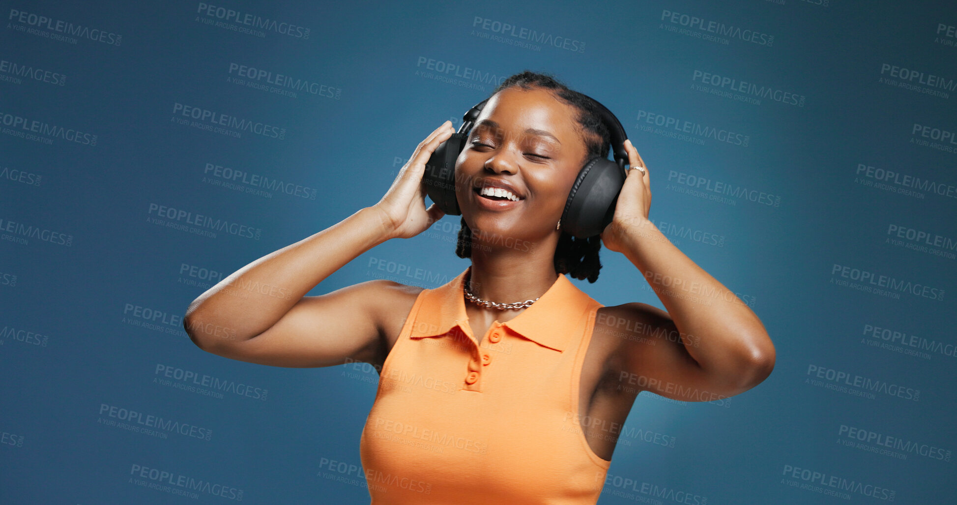 Buy stock photo Headphones, smile and black woman in studio for dance, listening and music playlist. Happy, audio tech and African female person with groove for album, radio or song for rhythm on blue background