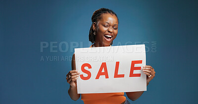 Buy stock photo Happy, black woman or discount with sale sign for marketing on a blue studio background. Female person, promoter or model with poster, billboard or advertising for offer, shopping deal or low price
