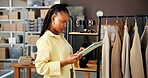 Small business, fashion and black woman on tablet for inventory, shipping and retail delivery. Startup, store and person with clothes on rail on digital tech for ecommerce, supplier and logistics