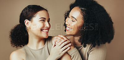 Buy stock photo Beauty, hug and smile with women in studio together for bonding, cosmetics or dermatology.  Aesthetic, satisfaction and skincare with sisters embracing on brown background for benefits or results