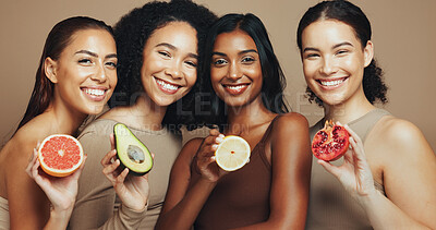 Buy stock photo Skincare, fruit and portrait of women in studio for beauty, wellness and organic products. Spa, dermatology and group of people with food for cosmetics, natural benefits and glow on brown background