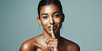 Skincare, portrait or happy woman with quiet gesture in studio, healthy glow or natural shine for wellness. Silence pose, dermatology secret or person with beauty surprise, space or green background