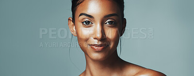 Buy stock photo Portrait, skincare and woman with glow in studio, natural beauty or dermatology. Face, shine and happy Indian model with cosmetics for aesthetic, health or banner on gray background with mockup space
