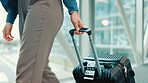 Person, hands or travel with suitcase in airport for business journey, work trip or commute. Closeup, employee or traveler with luggage for international boarding, corporate visit or job opportunity