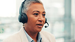 Mature woman, consultant and travel agency with headset for virtual asssistance or customer service. Female person, agent or employee talking with mic for schedule flight, help or telecommunications